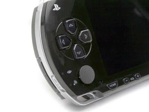 Close-up of a Sony PlayStation Portable (PSP) focusing on the left side with directional buttons and speakers.