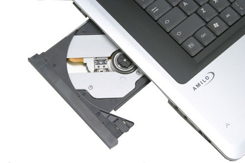 Close-up of the Fujitsu-Siemens AMILO M3438G gaming notebook with an open optical drive showing the disc tray and internal components.