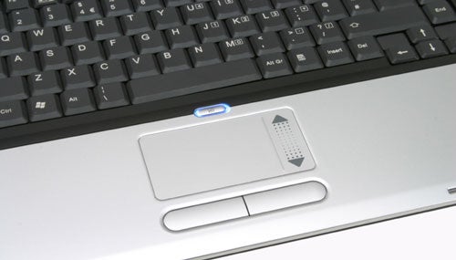 Close-up view of the touchpad area on a Fujitsu-Siemens AMILO M3438G gaming notebook, showcasing the keyboard and quick access buttons.