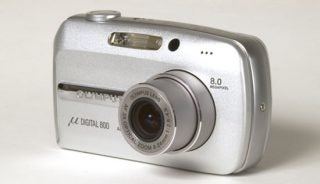Olympus µ [mju:] Digital 800 compact camera with a silver body, featuring an 8.0 megapixel sensor and a 3x optical zoom lens.
