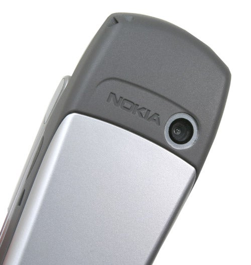 Close-up of the Nokia 6822 phone showing the camera lens and Nokia brand logo on the hinge of the flipped open handset.
