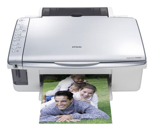 Epson Stylus DX4800 printer with printed photo of smiling family lying on grass coming out of the device.