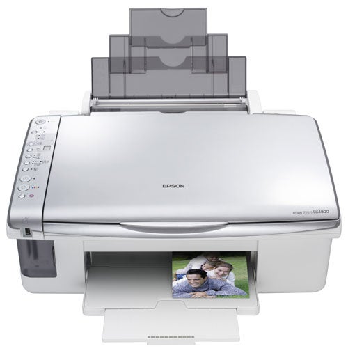 Epson Stylus DX4800 multifunction printer with paper output tray extended and a color photo print of two people emerging from the printer.