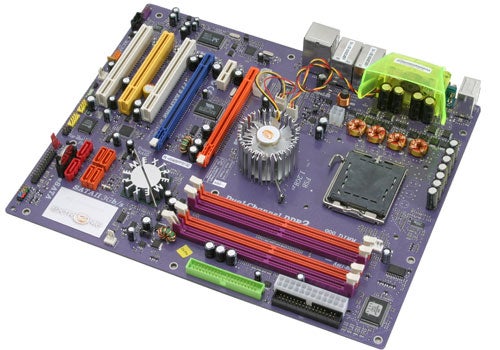 ECS PF5 Extreme Intel motherboard with colorful expansion slots, chipset cooling fan, and various connectors on a purple PCB.