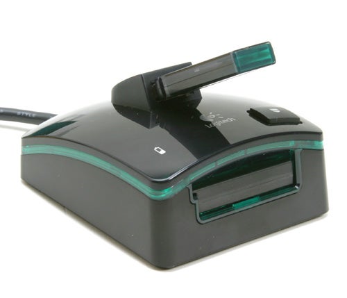 Logitech G7 cordless 2000dpi Laser Mouse charging dock with battery inserted and LED status indicator visible.