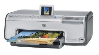 HP Photosmart 8250 printer with a color photo printout emerging from the device and an image preview on the small display screen.