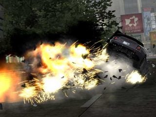 Screenshot of a car from the video game Burnout: Revenge involved in a high-speed crash with intense flames and sparks.