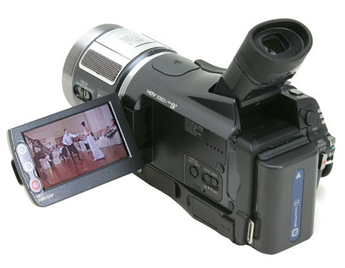 Sony HDR-HC1E high-definition camcorder with flip-out LCD screen displaying video content, viewed from a left side angle on a white background.