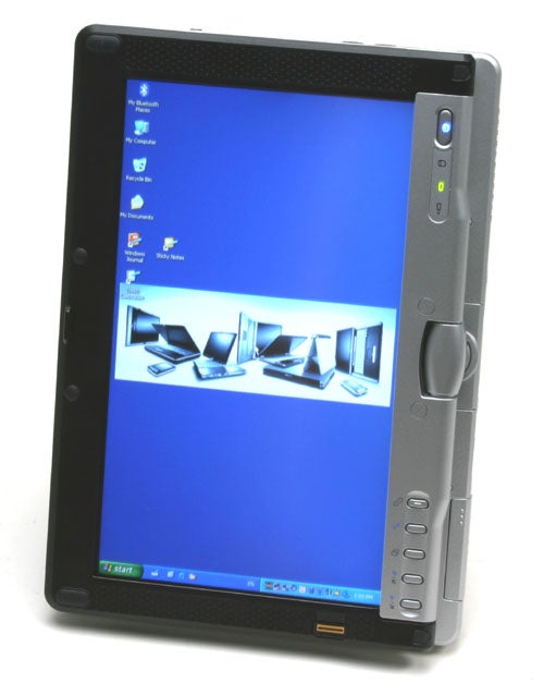 Vertical orientation of Fujitsu-Siemens Lifebook P1510 laptop with a stylus pen, displaying a blue desktop wallpaper and taskbar with 'Start' button visible. The right side of the frame shows the laptop's silver control buttons for screen orientation and other functions, along with LED indicators for power and battery status.