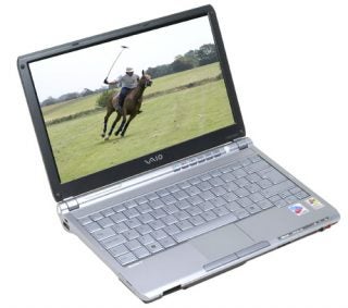 Sony VAIO VGN-TX1XP laptop open on a surface, displaying a wallpaper of a person riding a horse on its screen.