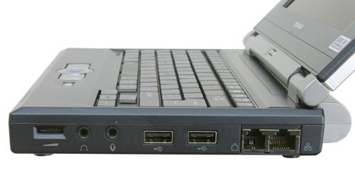 Close-up of a Toshiba Libretto U100 laptop focusing on its left-hand side ports, including USB, Ethernet, and video out, with the laptop lid open in the background.