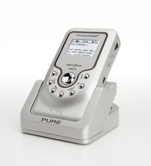 Pure Pocket DAB 2000 digital radio sitting in its docking station with a display screen showing playback information and menu options. The device has navigation and function buttons around the center and is branded with 