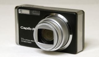 Ricoh Caplio R3 digital camera with a 7.1x optical zoom lens and 5.0 mega pixels, displayed on a plain background.