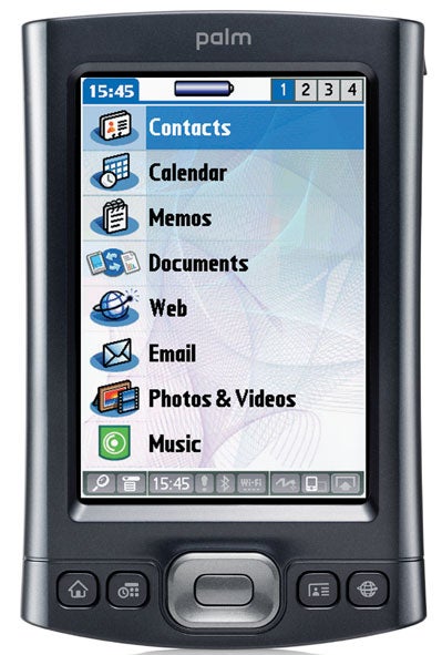 Palm T|X handheld organizer with a color screen displaying icons for Contacts, Calendar, Memos, Documents, Web, Email, Photos & Videos, and Music, with Wi-Fi connectivity symbol shown at the top.