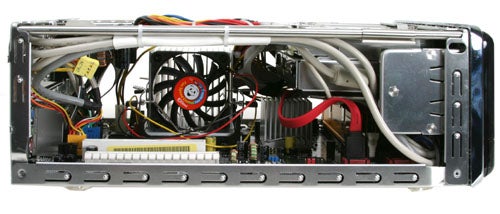 Interior view of AOpen XC Cube MZ915-M Small Form Factor Barebone computer showcasing the motherboard, CPU fan, power supply, and various cables and connectors.