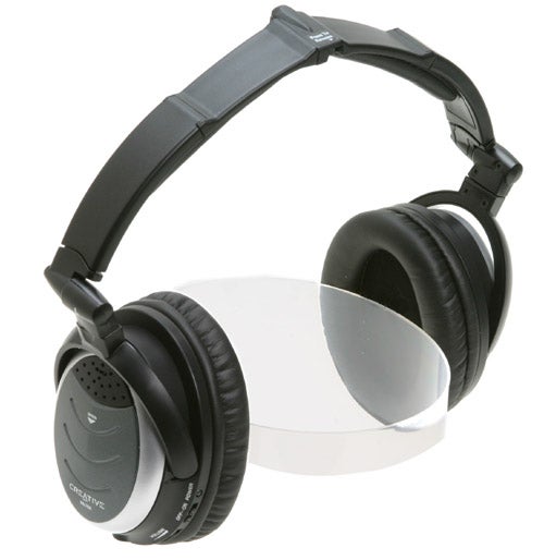 Creative HN-700 noise-cancelling headphones with black over-ear design on a reflective surface.