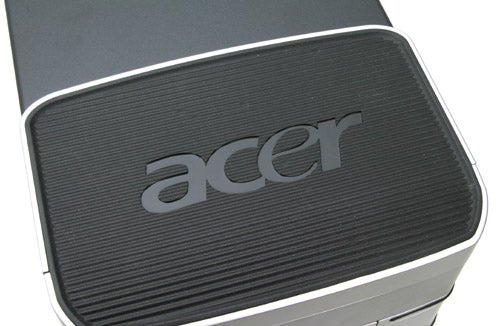 Close-up of the Acer logo on the textured surface of an Acer Aspire E300-7NB73 desktop computer.
