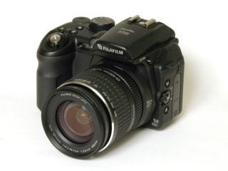 A Fujifilm FinePix S9500 digital camera with a zoom lens displayed on a white background.