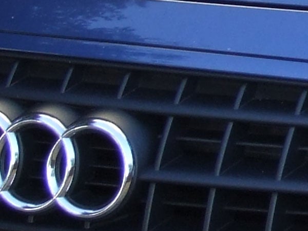 Close-up image of the front grille and badge on an Audi car.