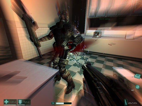 Screenshot from the video game F.E.A.R. showing a first-person view where the player's character is holding a shotgun aimed at an enemy soldier in a bathroom environment, with HUD elements displaying health, armor, and ammo count visible on screen.