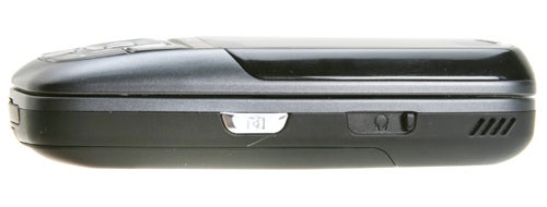 Side view of a closed Samsung SGH-D600 mobile phone showing its slim profile, external camera button, and speaker vents.