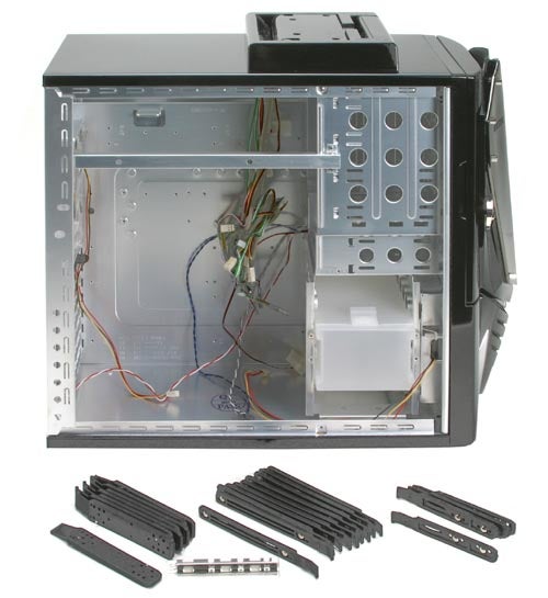 An open NZXT Nemesis Elite computer case with a side view, displaying its internal layout and empty drive bays alongside disassembled parts and loose cables.