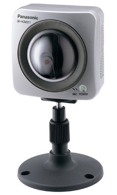 Panasonic BB-HCM311 network camera with a large lens in the center, microphone hole to the left, and power indicator on the right, mounted on a black stand.