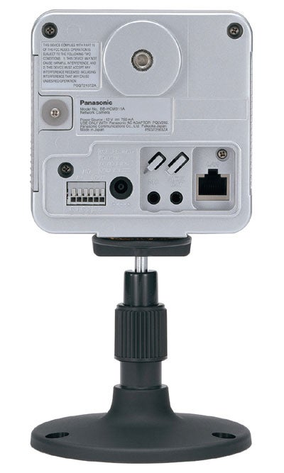 Rear view of a Panasonic BB-HCM311 network camera showing the back panel with various ports and connectors, mounted on its stand.