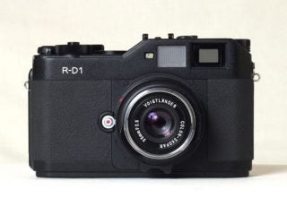 Epson R-D1 digital rangefinder camera with a Voigtlander lens on a white background.