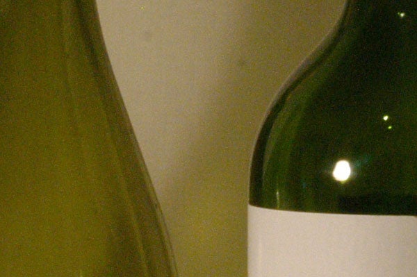 Close-up of the upper part of a green wine bottle showing detail and texture captured with an Epson R-D1 digital rangefinder camera.