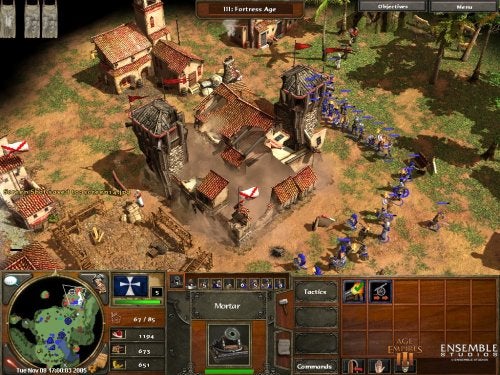 A screenshot of Age of Empires III gameplay showing a birds-eye view of a village with various buildings, units such as soldiers in blue and villagers, and a highlighted mortar in the unit selection area. The game interface includes a mini-map on the lower-left corner; resource counts for food, wood, and gold at the top; and unit and command options at the bottom.
