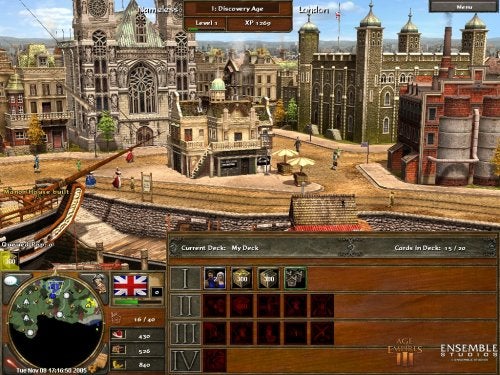 A screenshot of gameplay from Age of Empires III showing a European town with buildings and a small dock area, with user interface elements such as the mini-map, various resources and options displayed, and a bar for selecting 'Current Deck' with cards indicating in-game strategic choices.