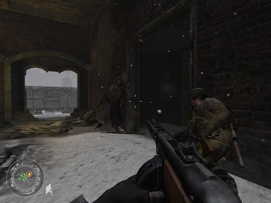 Screenshot from the video game Call of Duty 2 showing a first-person view of a player holding a rifle while moving through a snowy, war-torn environment with two soldiers crouching nearby.