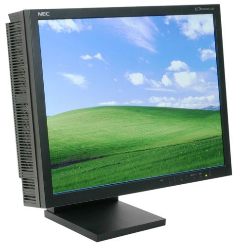 NEC SpectraView Reference 21 LCD2180WG LED monitor displayed on a stand, showing a vibrant green hill and clear blue sky on the screen.