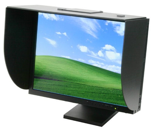 NEC SpectraView Reference 21 LCD2180WG LED monitor with black bezel, adjustable stand, and side shades displaying a landscape wallpaper.