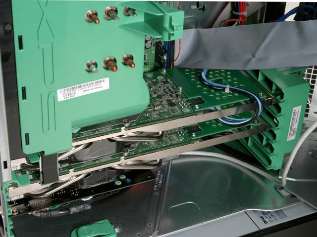 Interior view of a Dell XPS 600 desktop computer showing dual graphics cards configured in SLI mode with cables and green mounting brackets visible inside the case.