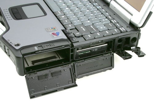 Panasonic ToughBook CF-29 rugged laptop with open DVD drive and battery compartment, highlighting its durable design and multiple ports.