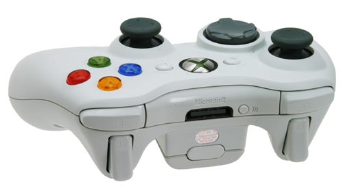 White Microsoft Xbox 360 wireless controller with colored buttons and dual analog sticks on a neutral background.