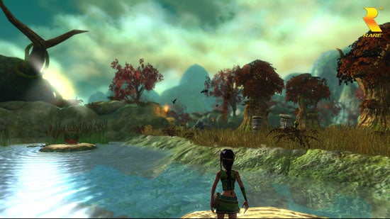 Screenshot from the video game Kameo: Elements of Power showing the main character standing at the edge of a serene waterbody with lush, colorful scenery and mythical structures in the background under a hazy sky.