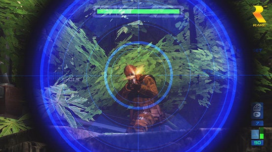 First-person view of a sniper scope targeting an enemy in the video game Perfect Dark Zero, with health bar and ammo count displayed on the HUD.
