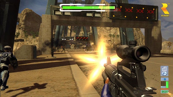 Screenshot from the video game 'Perfect Dark Zero' showing a first-person perspective of a player character firing a rifle with a scope attachment at enemy characters in a desert-like military base environment. A health bar, ammo count, and radar are visible in the heads-up display.