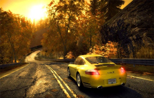 A yellow Porsche 911 Turbo with the license plate reading 'ND4SPD' driving on a wet autumn road flanked by trees with golden leaves, in the game Need for Speed: Most Wanted (2005), depicting the game's high-quality graphics and immersive environment.