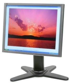 ViewSonic VP930 19-inch TFT monitor displaying a vibrant sunset image with a clear view of clouds and lake, standing on a black star-shaped base.