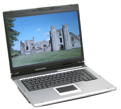 Asus A6Km-Q002H laptop displayed open with a castle wallpaper on the screen.