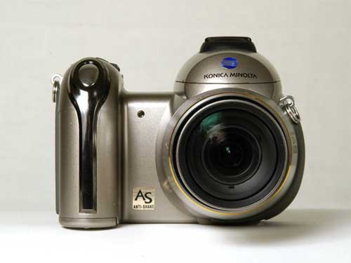 Konica Minolta Dimage Z6 digital camera with a large zoom lens and anti-shake feature, displayed against a white background.