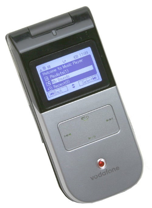 A Toshiba TS803 mobile phone with the music player interface displayed on the screen, branded by Vodafone.