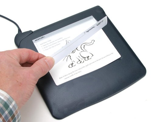 Hand holding a stylus and drawing a sketch of a cat on the Acecad Acecat Flair graphics tablet.