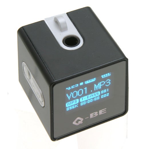 SupportPlus Q-BE MP3 player displayed against a white background showing screen interface with a song titled 'V001.MP3' and other playback details.