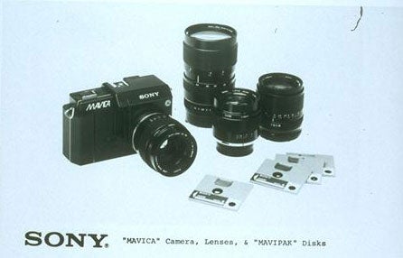 Sony Mavica camera, lenses, and floppy disks displayed