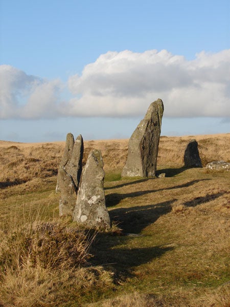 Standing stones in a field on a sunny day.